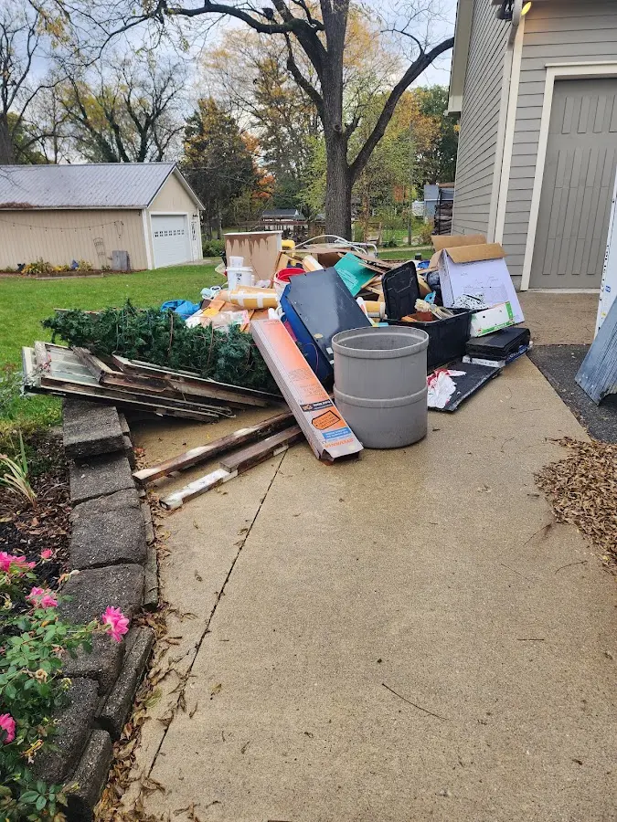 Dumpster being loaded with debris for 3 Yard Dumpster Rental in Two Harbors